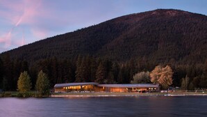 A lakeside lodge with a long building, surrounded by a forested mountain and a calm lake. - GM239: Private Hot Tub + Family/Dog Friendly + Central AC (Sisters)