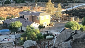 A residential area with a house, swimming pool, and construction materials. - Hope House, resort style with mountain view (Perris)