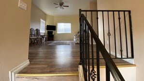 A staircase with a black railing leading to a second floor. - Hope House, resort style with mountain view (Perris)