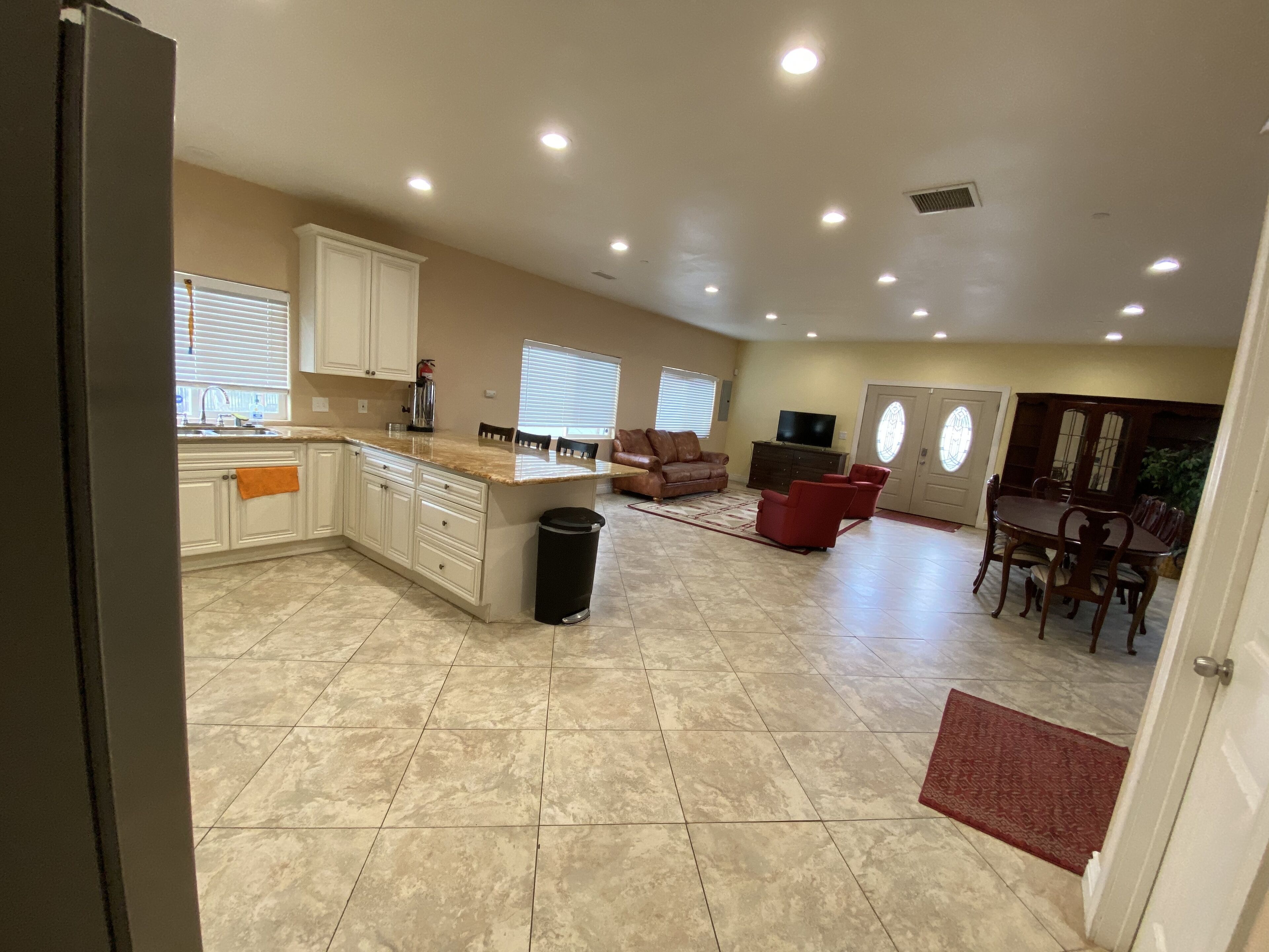 A spacious living area with a kitchen, dining area, and seating.