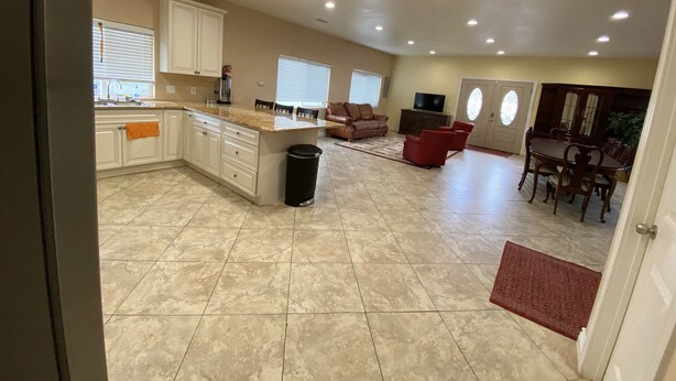 A spacious living area with a kitchen, dining area, and seating. - Hope House, resort style with mountain view (Perris)