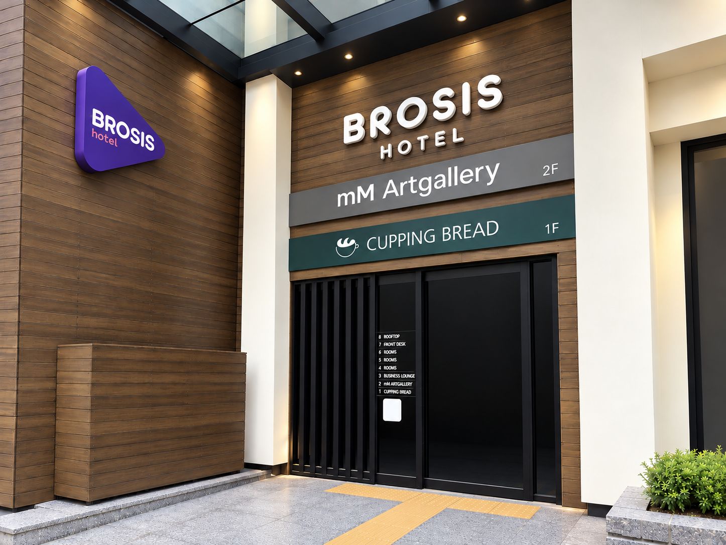 Entrada de un hotel con un cartel que indica 'Brosis Hotel' y 'mM Art Gallery'.