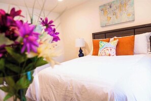 Enjoy a restful stay in this beautifully appointed room with a comfortable bed, elegant vase, and wall-mounted artwork.