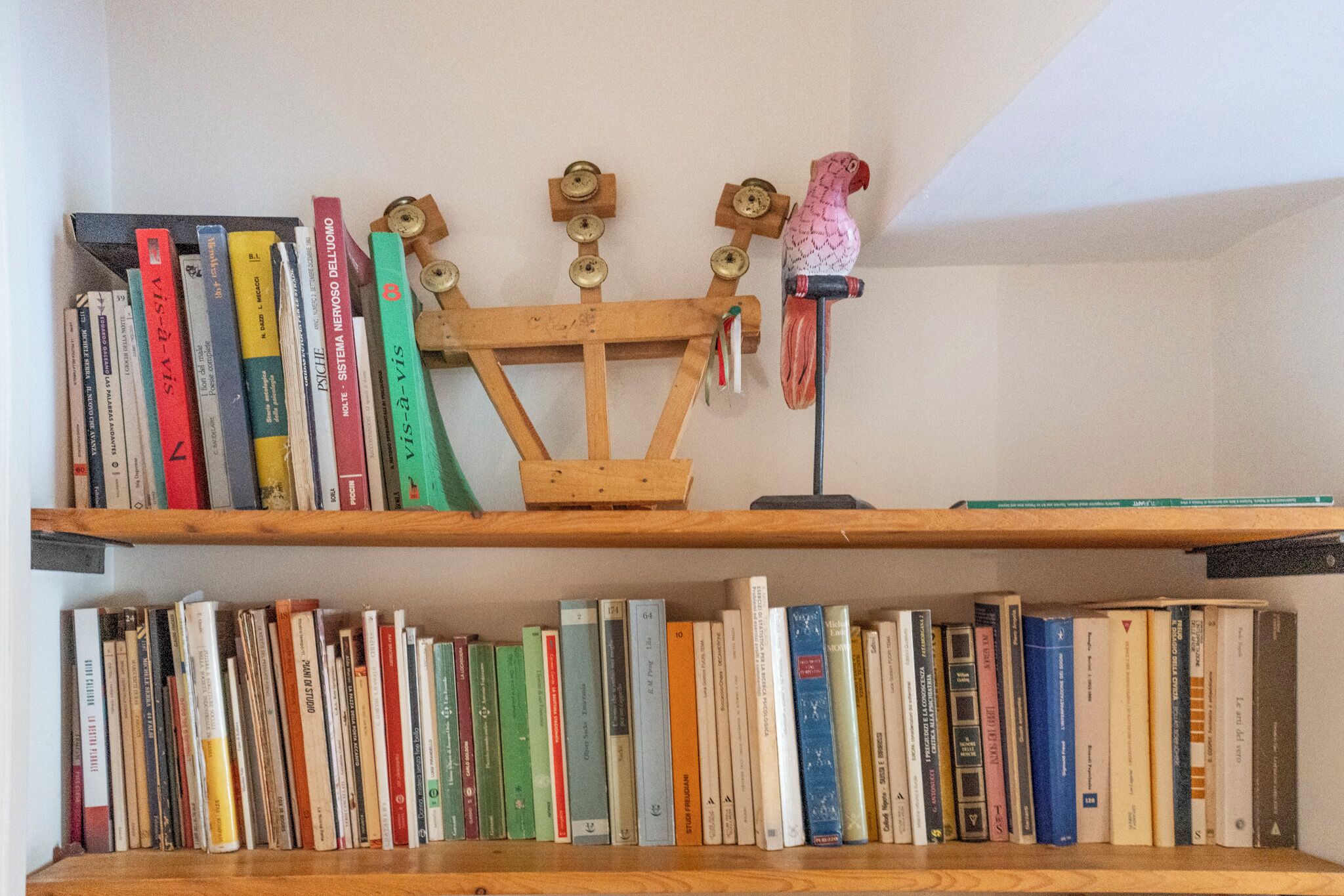 A bookshelf with books and a wooden structure.