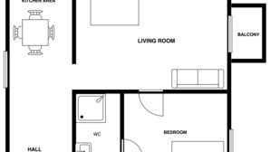 Een plattegrond met een keuken, woonkamer, balkon, slaapkamer, toilet en hal.