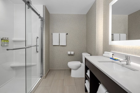Separate tub and shower, free toiletries, hair dryer, slippers. Holiday Inn Express & Suites Woodside LaGuardia Airport by IHG