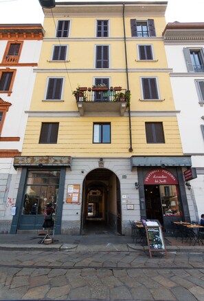 A multi-story building with a ground-floor shop.