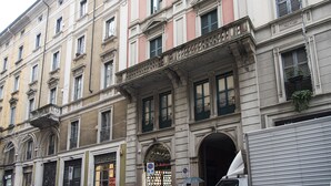 A multi-story building with a classic architectural style, featuring balconies, large windows, and a prominent entrance.