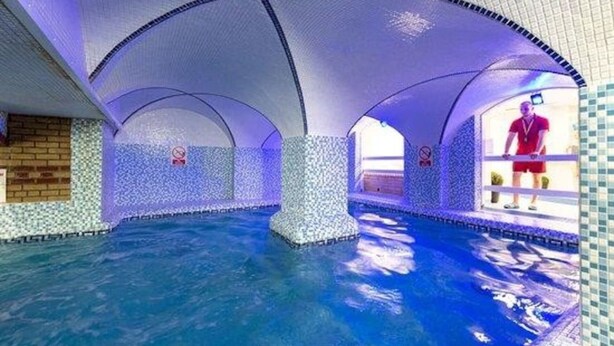 An indoor swimming pool with arched ceilings and tiled walls. - Caravan Nearby Hastings, Coghurst Hall Park (Hastings)