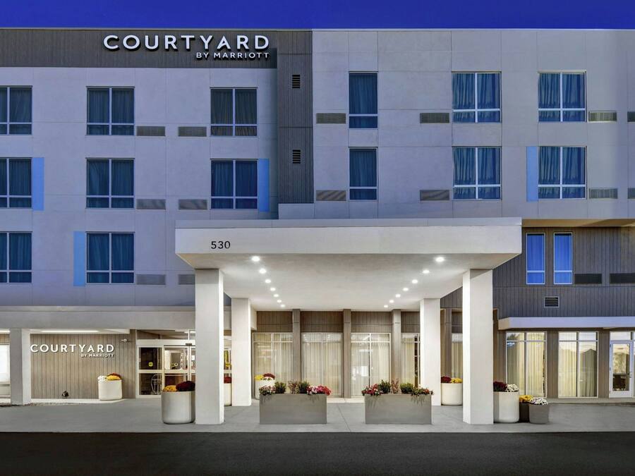 A modern hotel entrance with a sign reading "COURTYARD BY MARRIOTT" and a number "530" above the entrance.