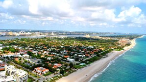 A coastal cityscape with a beachfront, residential areas, and a prominent hotel with a large building and a pool. - 1/1 steps from downtown w/bikes. clean & comfortable (West Palm Beach)