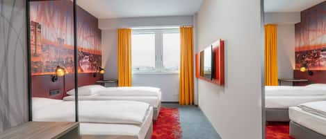 A hotel room with three beds, a large mirror, a cityscape painting, and a window with yellow curtains.