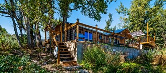 Single-level, lakefront getaway with mini-bar, furnished deck & mountain views
