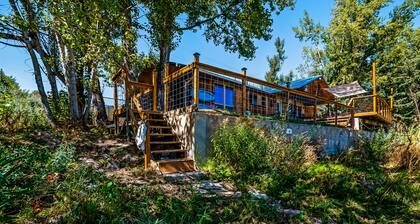 Single-level, lakefront getaway with mini-bar, furnished deck & mountain views