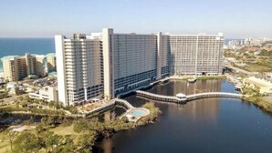 A large hotel with multiple high-rise buildings, a central courtyard, and a body of water.