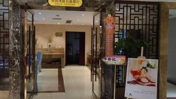 An entrance to a restaurant with a sign indicating it is an exotic café.