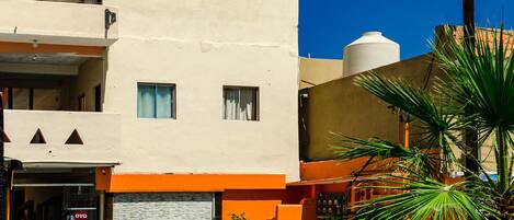 A building with a flat facade, two windows, and a door.