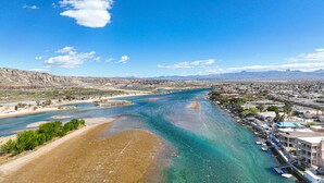 A coastal town with a river, clear waters, and a mix of residential and commercial buildings.