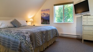 A bedroom with a bed, a TV, a poster, a window, and a dresser. - Scenic House Located At The Doorstep to West Glacier National Park Entrance
 (West Glacier)