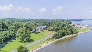 A lakeside property with a road, a dock, and buildings surrounded by greenery. - Historic, Elegant, Luxurious. (Mechanicsville)