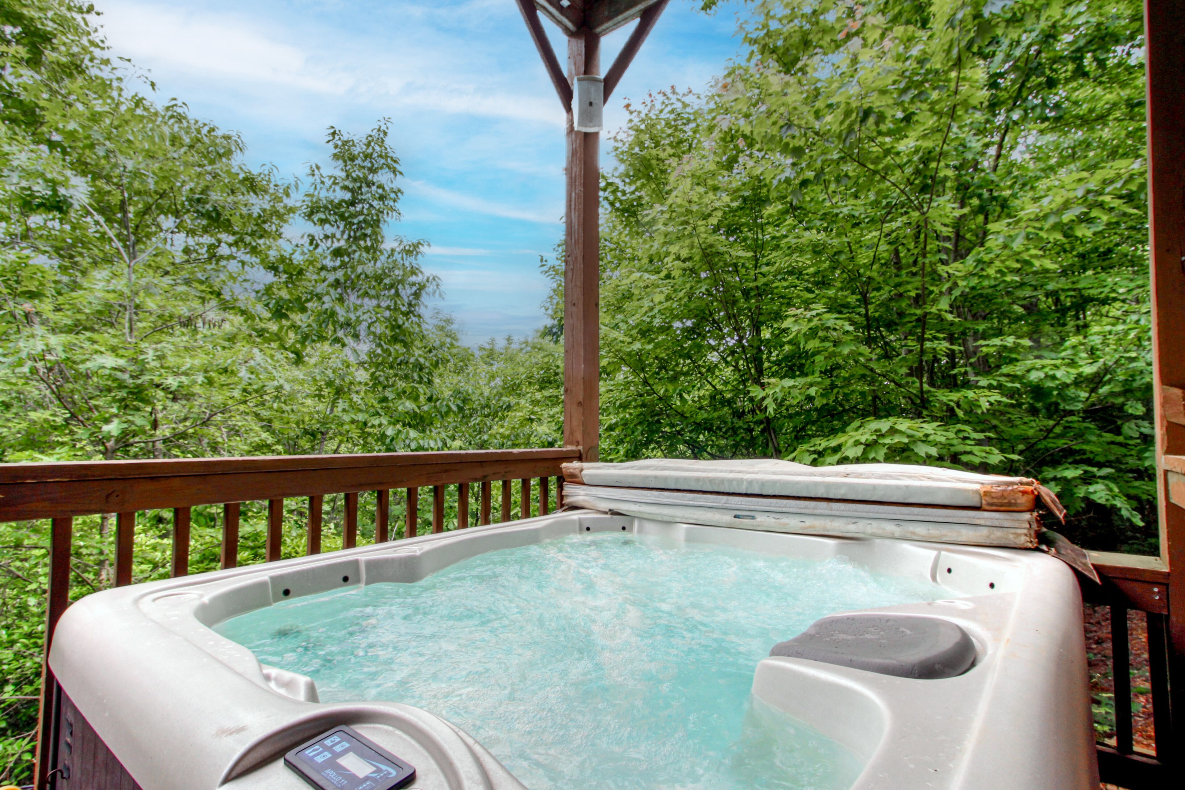 Dog-friendly mountain cabin with a furnished deck, game room & private hot tub
