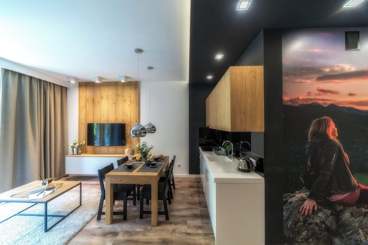 A modern kitchen with wooden cabinets and a built-in oven.