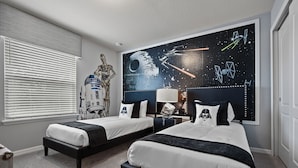 A bedroom with two beds, Star Wars-themed wall art, and a window with blinds. - PROMO Magical 10 BR Villa, Pool/Spa, Resort - by Blue Sky Villas (Kissimmee)