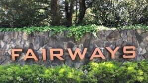 A stone wall with the word "FAIRWAYS" in large letters.