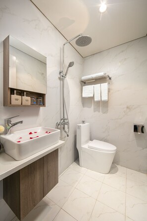 A modern bathroom with a marble sink, a shower, and a toilet. - P-Link Home & Hotel (Hanoi)