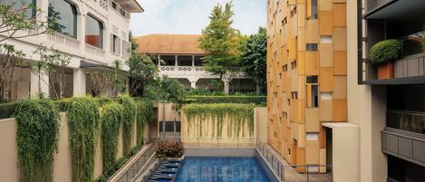 Outdoor pool, open 7:00 AM to 10:00 PM, sun loungers