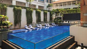 Outdoor pool, open 7:00 AM to 10:00 PM, pool loungers
