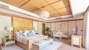 A spacious bedroom with a large bed, bedside tables, a bench, a sofa, and a TV. - L'Escale Resort Marina & Spa (Mahé Island)