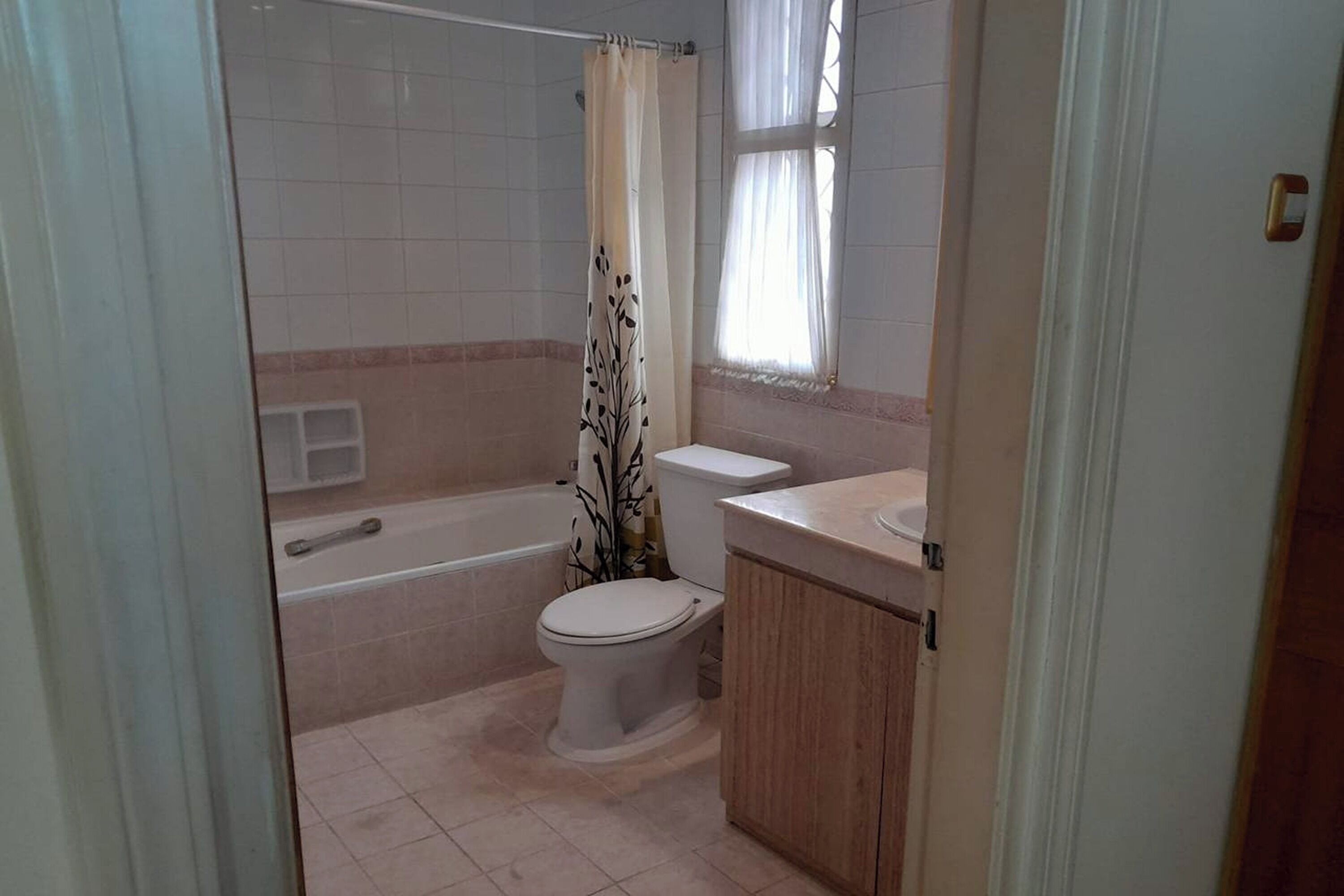 A bathroom with a bathtub, toilet, and sink.