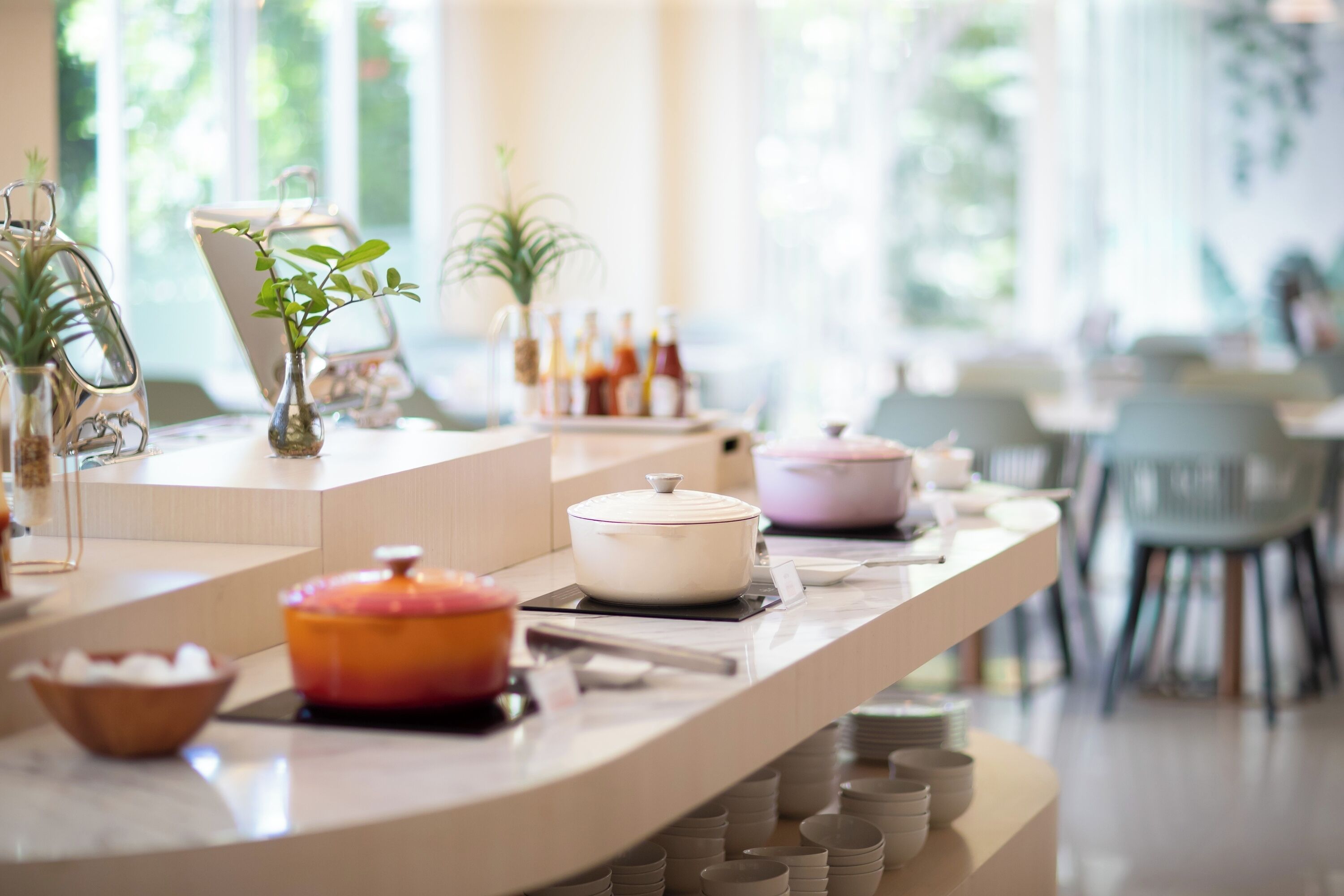 A buffet setup with various dishes and condiments.