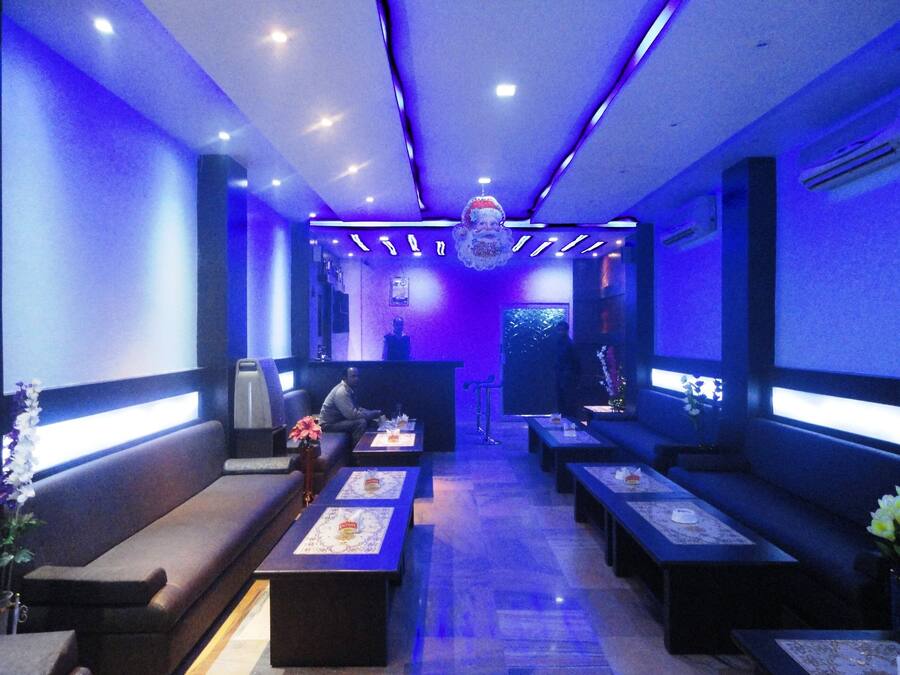 A reception area with seating, a counter, and a decorative hanging.