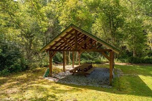A wooden gazebo with a picnic table in a forested area. - Horseshoe Hollow, Private Log Cabin on 10 acres (Lake Toxaway)