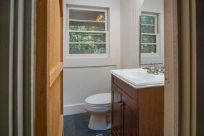 A bathroom with a toilet, a sink, and a window. - Horseshoe Hollow, Private Log Cabin on 10 acres (Lake Toxaway)