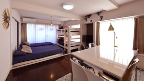 A compact room with bunk beds, a dining table, and a world map on the wall. - Hostel Inn Tokyo Kuramae (Tokyo)