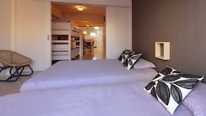A bedroom with a bed, two pillows, a chair, and a wardrobe. - Hostel Inn Tokyo Kuramae (Tokyo)