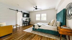 A bedroom with a bed, a sofa, a desk, and a ceiling fan. - Pet friendly studio apartment. Minimal shedding dogs only.1 dog max.$25 pet fee (Kill Devil Hills)