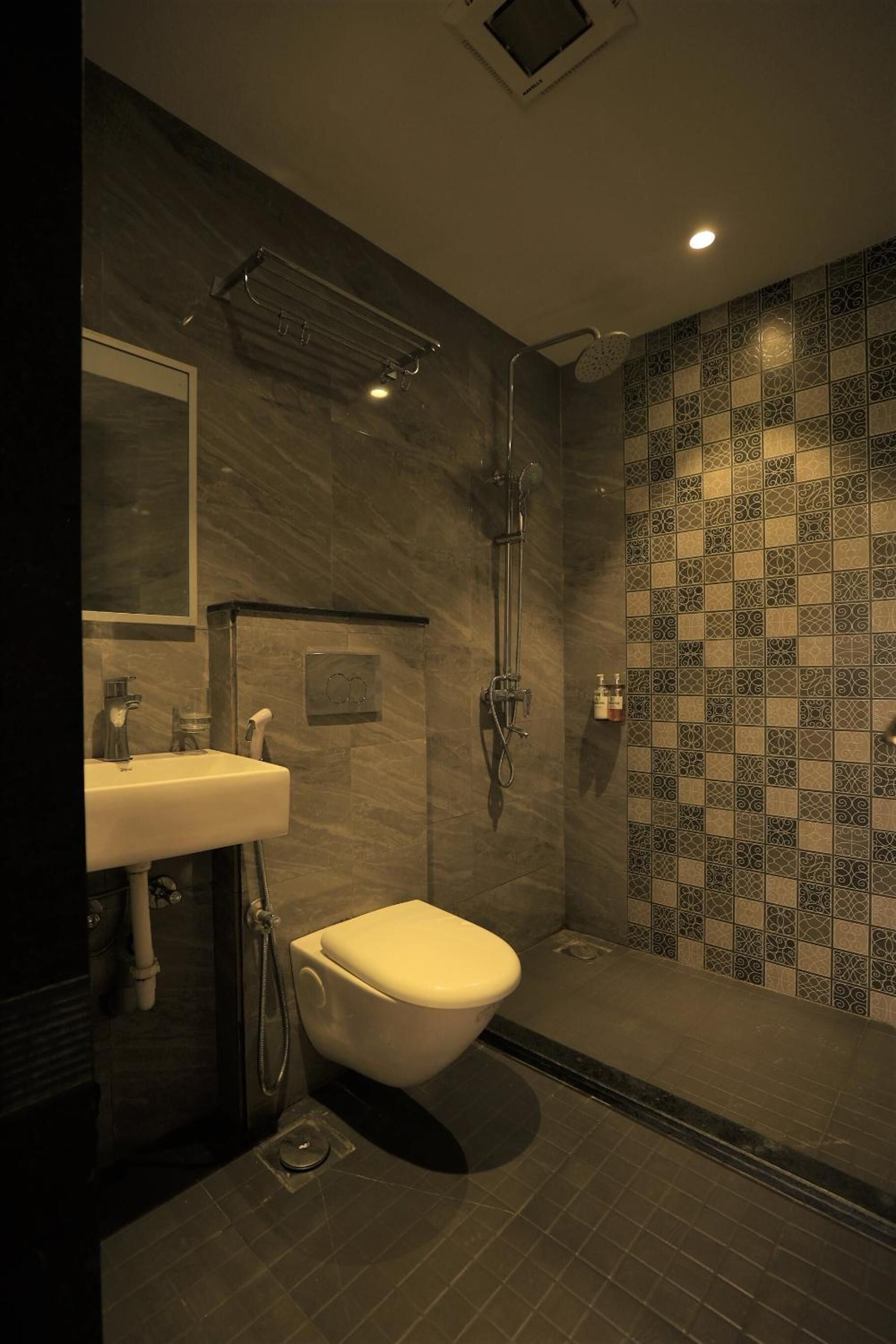A modern bathroom with a shower, toilet, and sink.