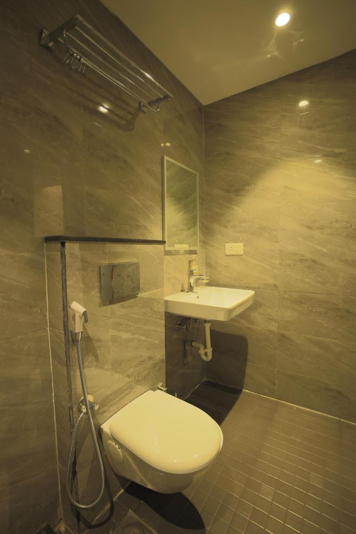 A modern bathroom with a toilet, sink, and shower.