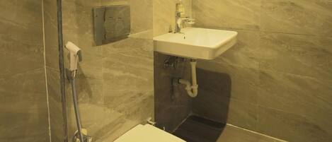 A modern bathroom with a toilet, sink, and shower.