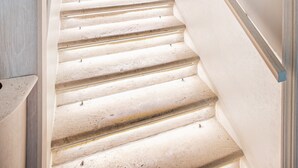 A staircase with a light-colored finish, leading to a room with a door and a wall-mounted mirror. - Heritage Villa Nobile Adults Only (Dubrovnik)