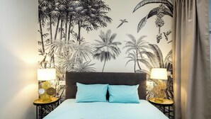 A bedroom with a bed, two nightstands, a tray with mugs, and a book titled "Sustainable Ability". - CITY HOUSE SA FONT IN SANTA CATALINA (Palma)