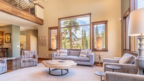 A spacious living room with a large sofa, a coffee table, and multiple seating options. - Short Walk to River Run, Private Hot Tub, Tons of Sunshine and Natural Light (Keystone)