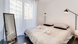 A bedroom with a large bed, two bedside lamps, a mirror, and a window with sheer curtains. - 🎖 Le Chevène - 2 or 4 person apartment with balcony in Annecy Centre (Annecy)