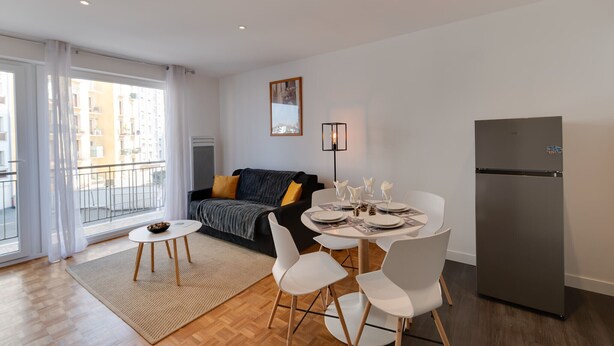A modern apartment with a dining area, a sofa, and a refrigerator. - 🎖 Le Chevène - 2 or 4 person apartment with balcony in Annecy Centre (Annecy)