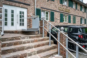 Welcome to Vintage, a charming entrance with a white door and stone steps.