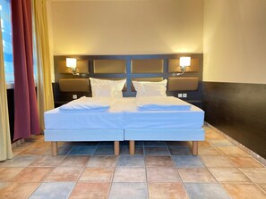 Enjoy a restful stay in this cozy room with a twin bed, bedside tables, and a headboard with lighting.